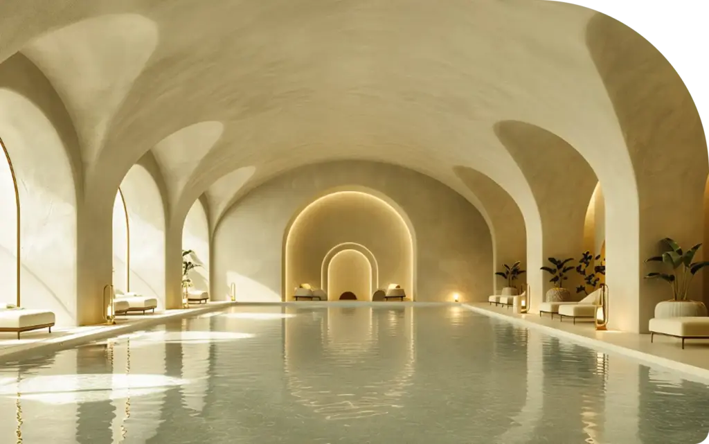 Kemerli tavanları ve yumuşak aydınlatmasıyla sakin ve zarif bir spa atmosferi yaratan lüks kapalı yüzme havuzu.